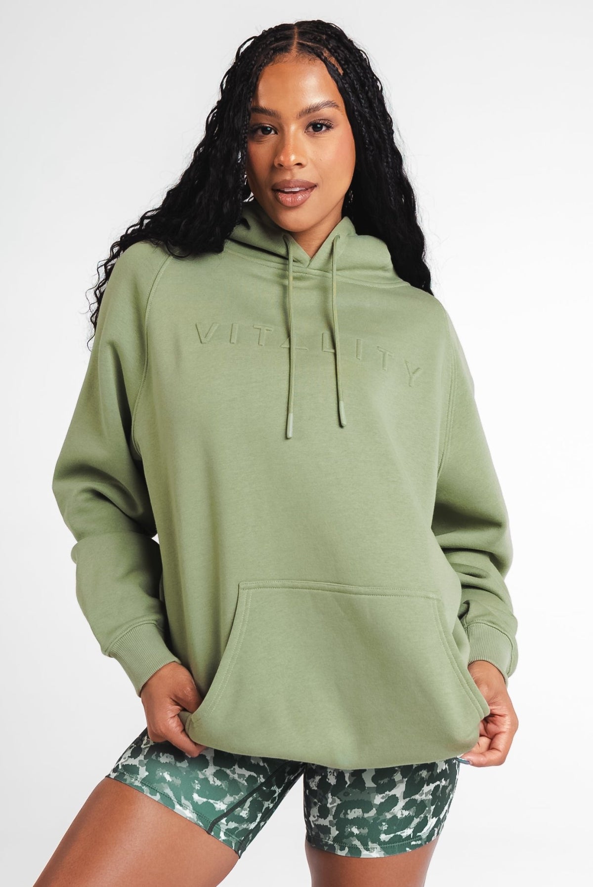 A woman wearing Vitality's Uni Maker Hood in Matcha