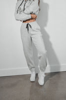 A woman wearing the Vitality Cozy Uni Jogger in Stone Marl