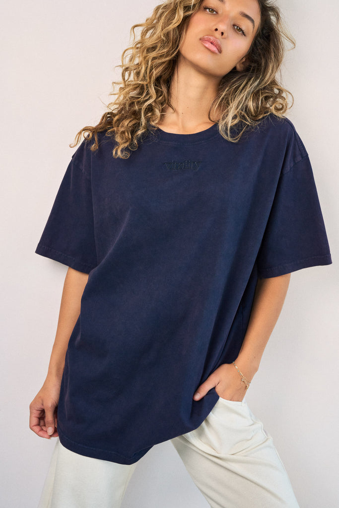 A woman wearing the Vitality Retro Uni Tee - Oxford Washed
