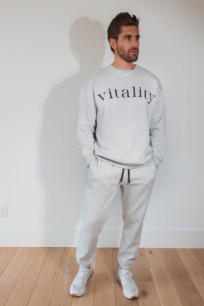 A man wearing the Vitality Cozy Uni Crew in Stone Marl